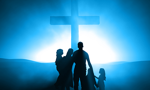 Silhouettes of a family at the Cross of Jesus.