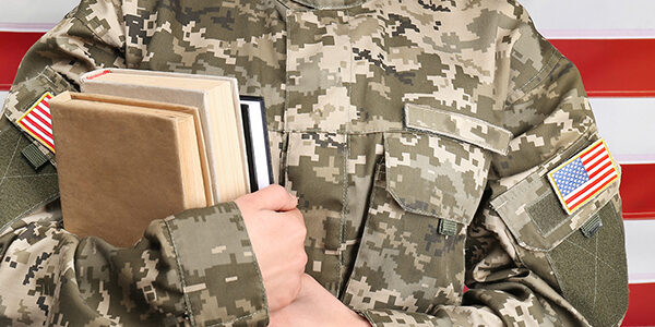 Female cadet of military school on flag background